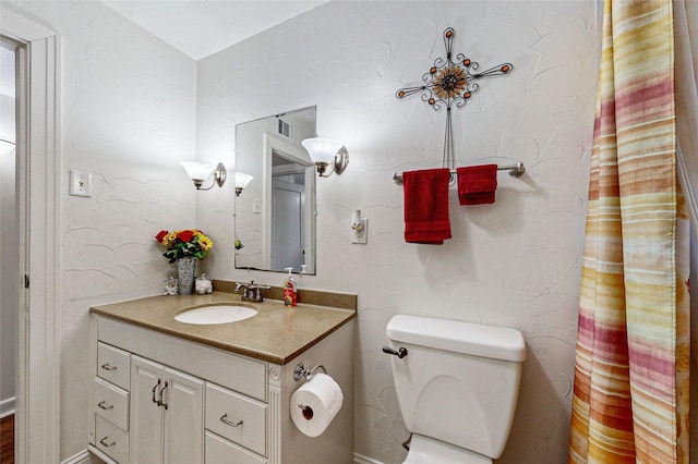 bathroom with toilet and vanity