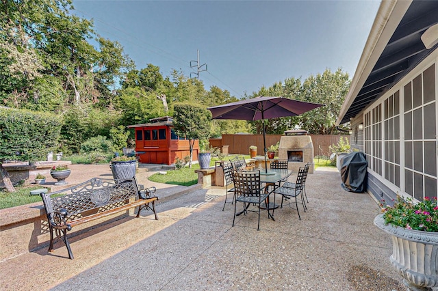 view of patio featuring an outdoor fireplace and grilling area