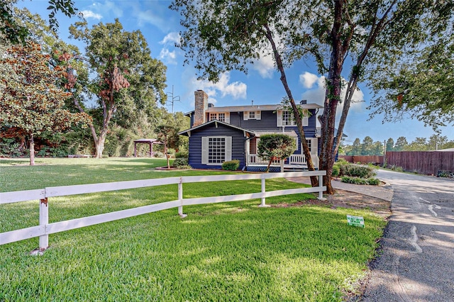 view of front of house featuring a front lawn and a gazebo