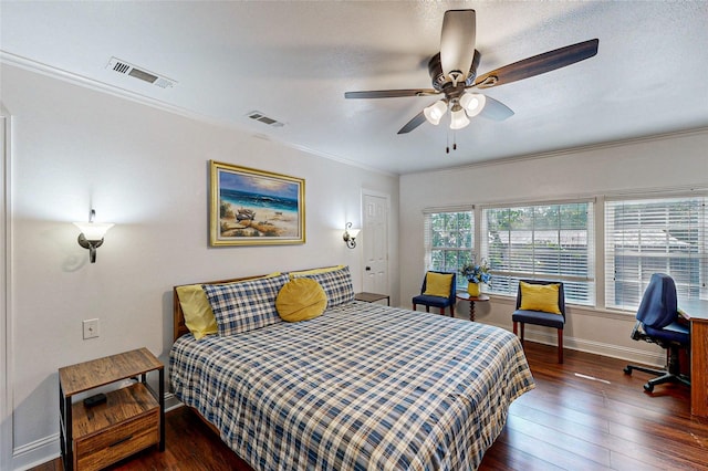 bedroom with ceiling fan, dark hardwood / wood-style flooring, and ornamental molding