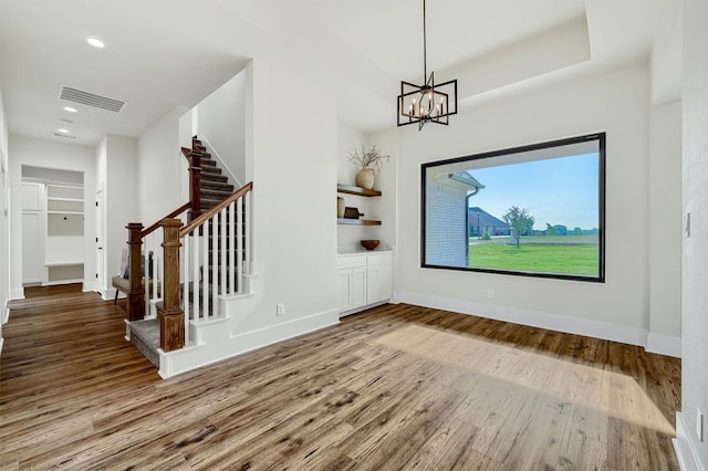 foyer featuring hardwood / wood-style flooring and an inviting chandelier