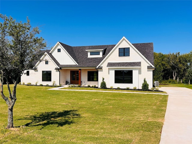 modern farmhouse style home with a front lawn