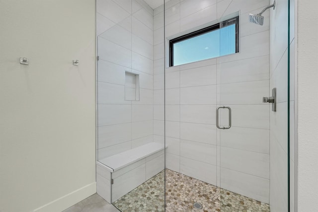 bathroom with a shower with door