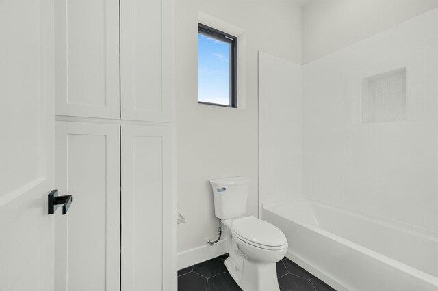 bathroom with  shower combination, toilet, and tile patterned flooring