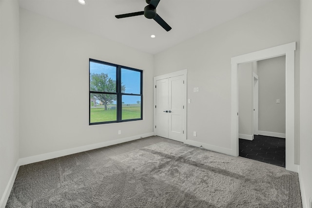 unfurnished bedroom featuring ceiling fan and carpet floors