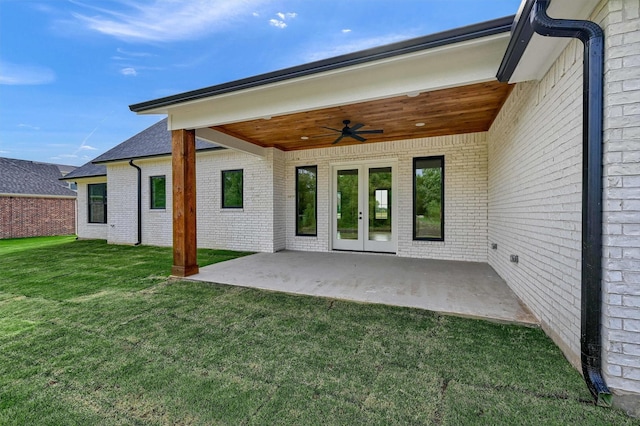 rear view of property with a patio area, french doors, ceiling fan, and a lawn