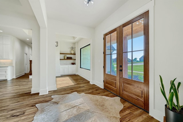 foyer featuring hardwood / wood-style floors and french doors