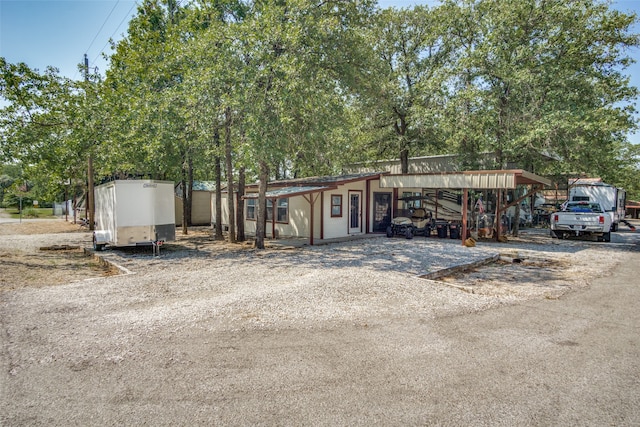 view of front of property featuring a carport