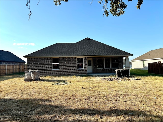 back of property featuring a yard