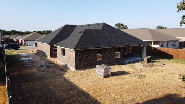 view of property exterior featuring a lawn and a patio area