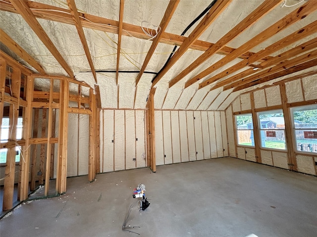 miscellaneous room with concrete floors and lofted ceiling