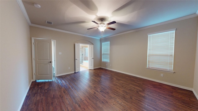 empty room featuring plenty of natural light, crown molding, dark hardwood / wood-style flooring, and ceiling fan