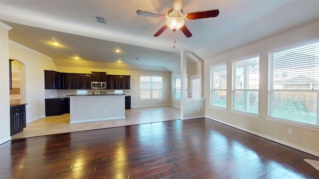 unfurnished living room featuring crown molding, hardwood / wood-style flooring, and ceiling fan