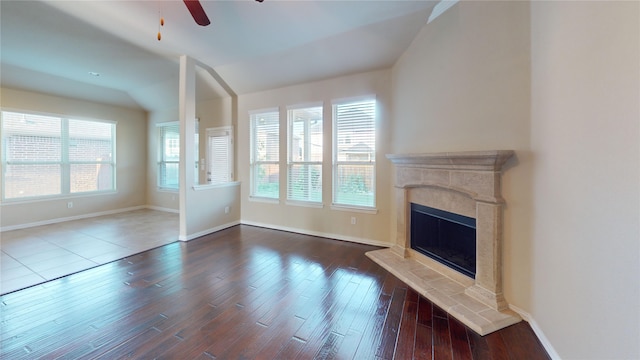 unfurnished living room featuring dark wood-type flooring, a fireplace, and ceiling fan