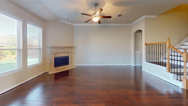 unfurnished living room with dark hardwood / wood-style floors, crown molding, and a wealth of natural light