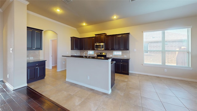 kitchen with stainless steel appliances, ornamental molding, light hardwood / wood-style floors, and a healthy amount of sunlight