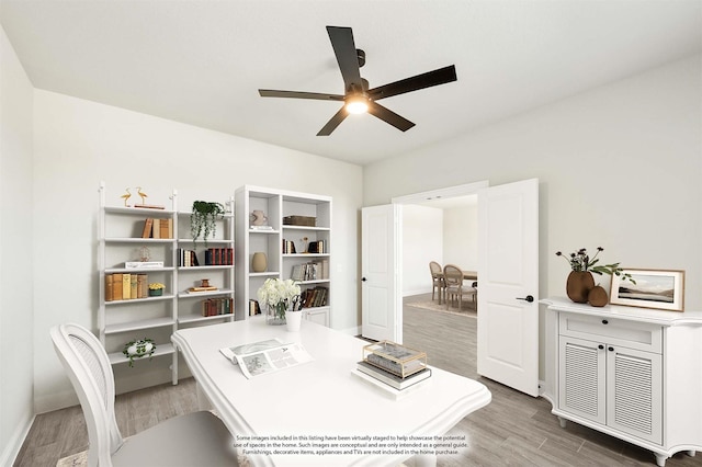 office area with wood finished floors, a ceiling fan, and baseboards