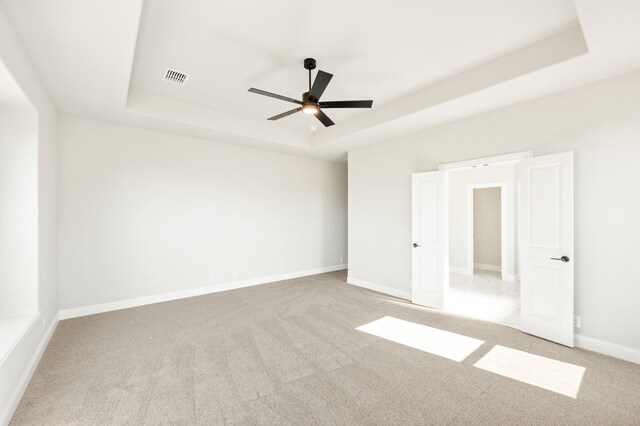 living room featuring ceiling fan, sink, a towering ceiling, and a stone fireplace