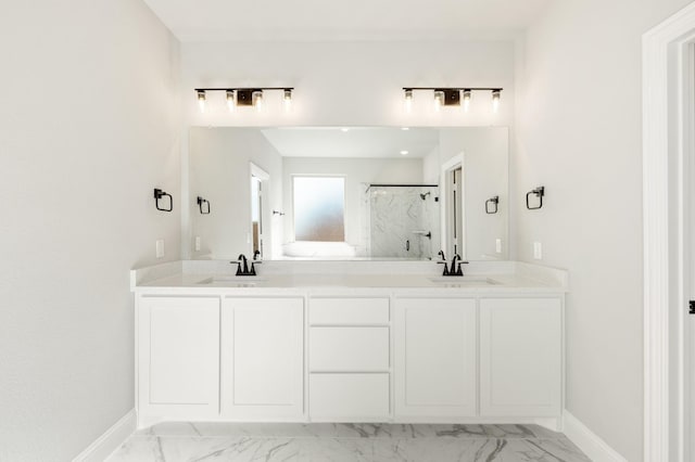 bathroom featuring marble finish floor, a sink, a marble finish shower, and baseboards