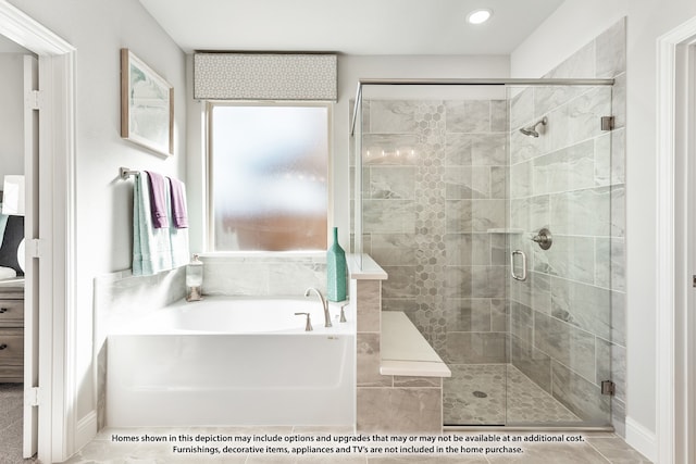 bathroom featuring tile patterned floors and independent shower and bath