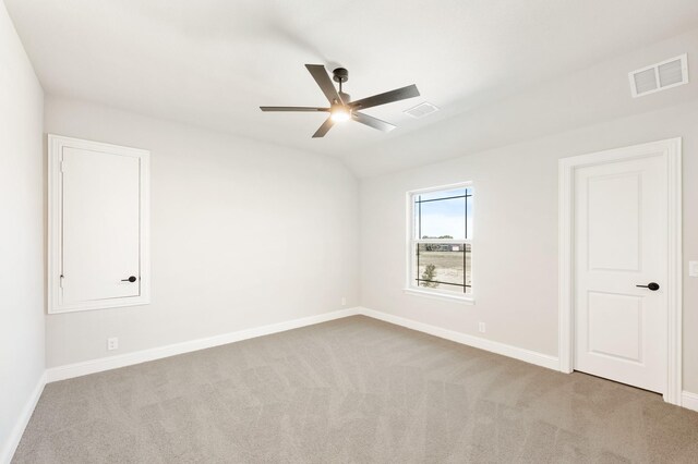 carpeted living room featuring ceiling fan and vaulted ceiling