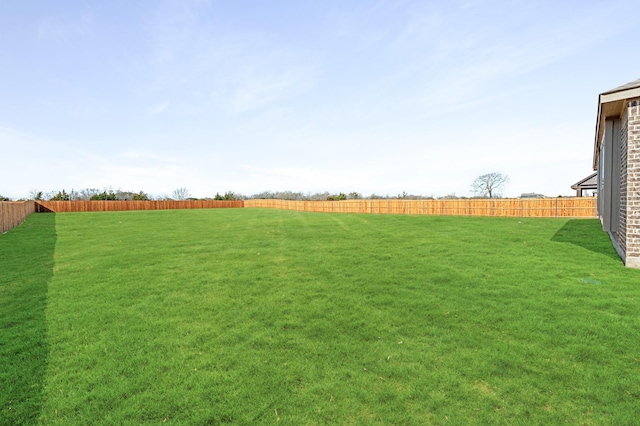 view of yard with a fenced backyard