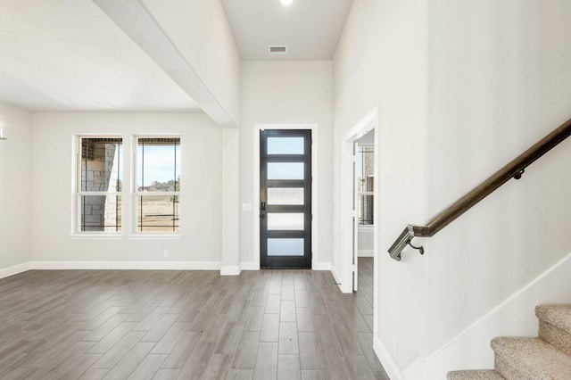 dining space with hardwood / wood-style floors and a notable chandelier