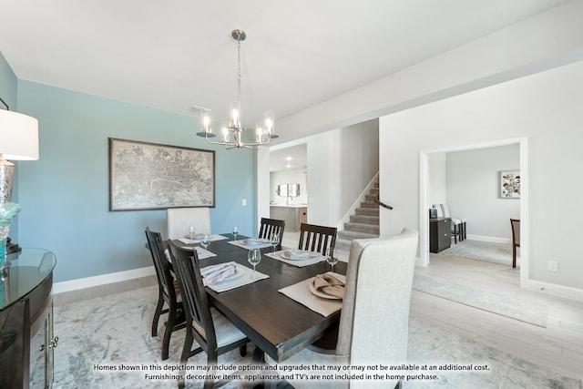 dining space featuring a chandelier and light hardwood / wood-style floors