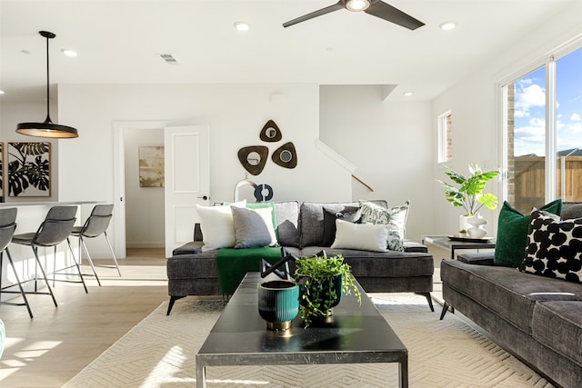 living room with ceiling fan and light wood-type flooring