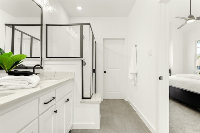 bathroom with ceiling fan, a shower with door, vanity, and tile patterned floors