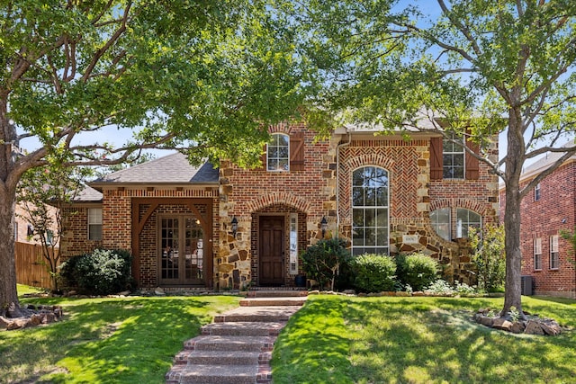 view of front of house with french doors and a front yard