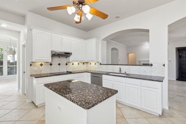 kitchen featuring ceiling fan, dishwasher, dark stone countertops, light tile patterned flooring, and tasteful backsplash