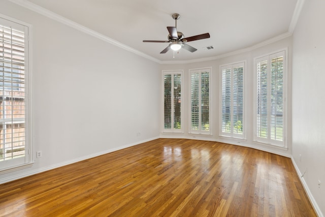 spare room featuring ceiling fan, hardwood / wood-style flooring, and crown molding