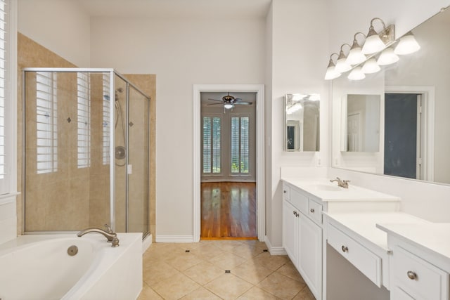 bathroom with ceiling fan, wood-type flooring, shower with separate bathtub, and vanity