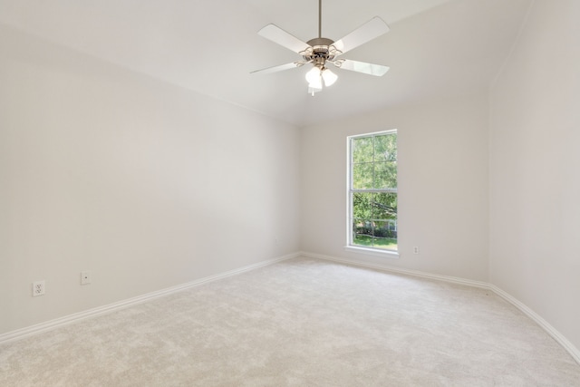 unfurnished room with ceiling fan and light carpet