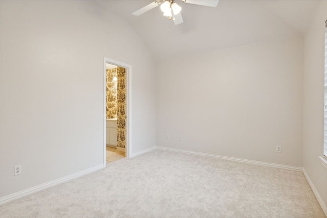 unfurnished room with ceiling fan, lofted ceiling, and light carpet