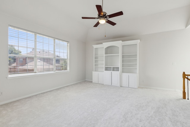 carpeted spare room featuring ceiling fan and lofted ceiling