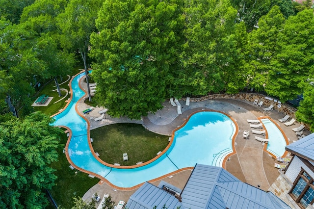 view of pool with a water slide and a patio