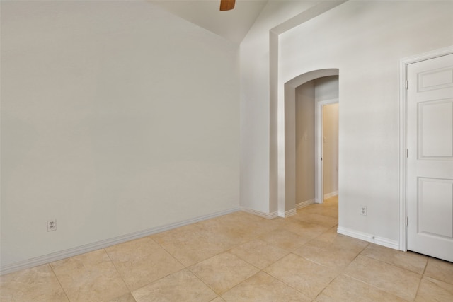 tiled empty room with ceiling fan and lofted ceiling