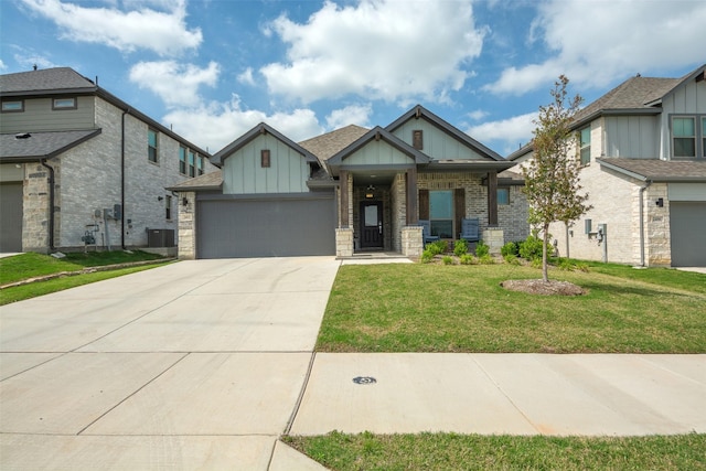 craftsman-style house with central air condition unit, concrete driveway, board and batten siding, a front yard, and a garage