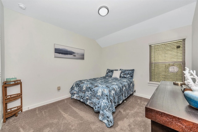 bedroom with lofted ceiling, carpet, and baseboards