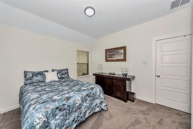 bedroom featuring carpet and vaulted ceiling