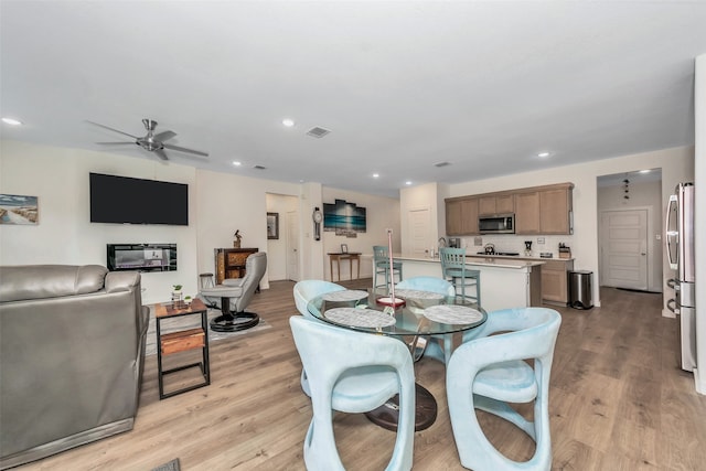 dining area featuring ceiling fan and light hardwood / wood-style flooring