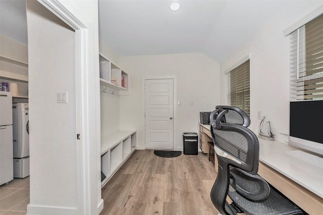 office space featuring vaulted ceiling and light wood finished floors