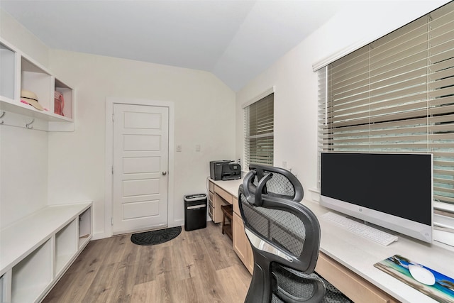 home office with lofted ceiling and light hardwood / wood-style floors