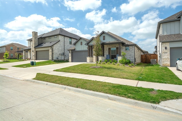 view of front facade with brick siding, concrete driveway, board and batten siding, a front yard, and fence