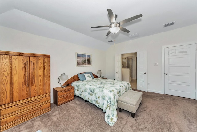 bedroom with lofted ceiling, ensuite bath, carpet, and visible vents