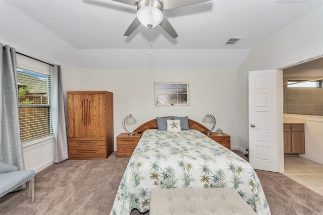 bedroom featuring light carpet, vaulted ceiling, visible vents, and a ceiling fan