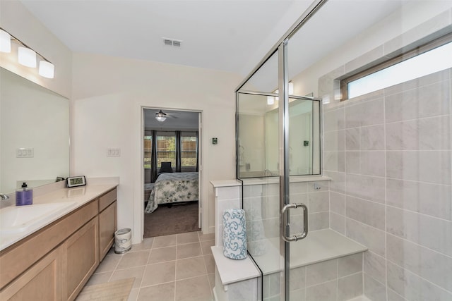 bathroom featuring ceiling fan, walk in shower, vanity, and tile patterned flooring