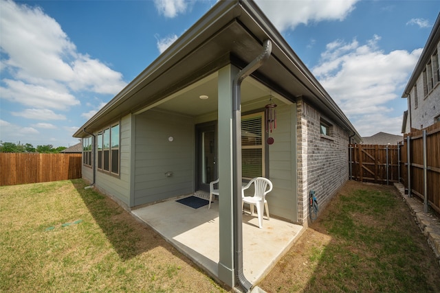 back of house featuring a patio and a yard